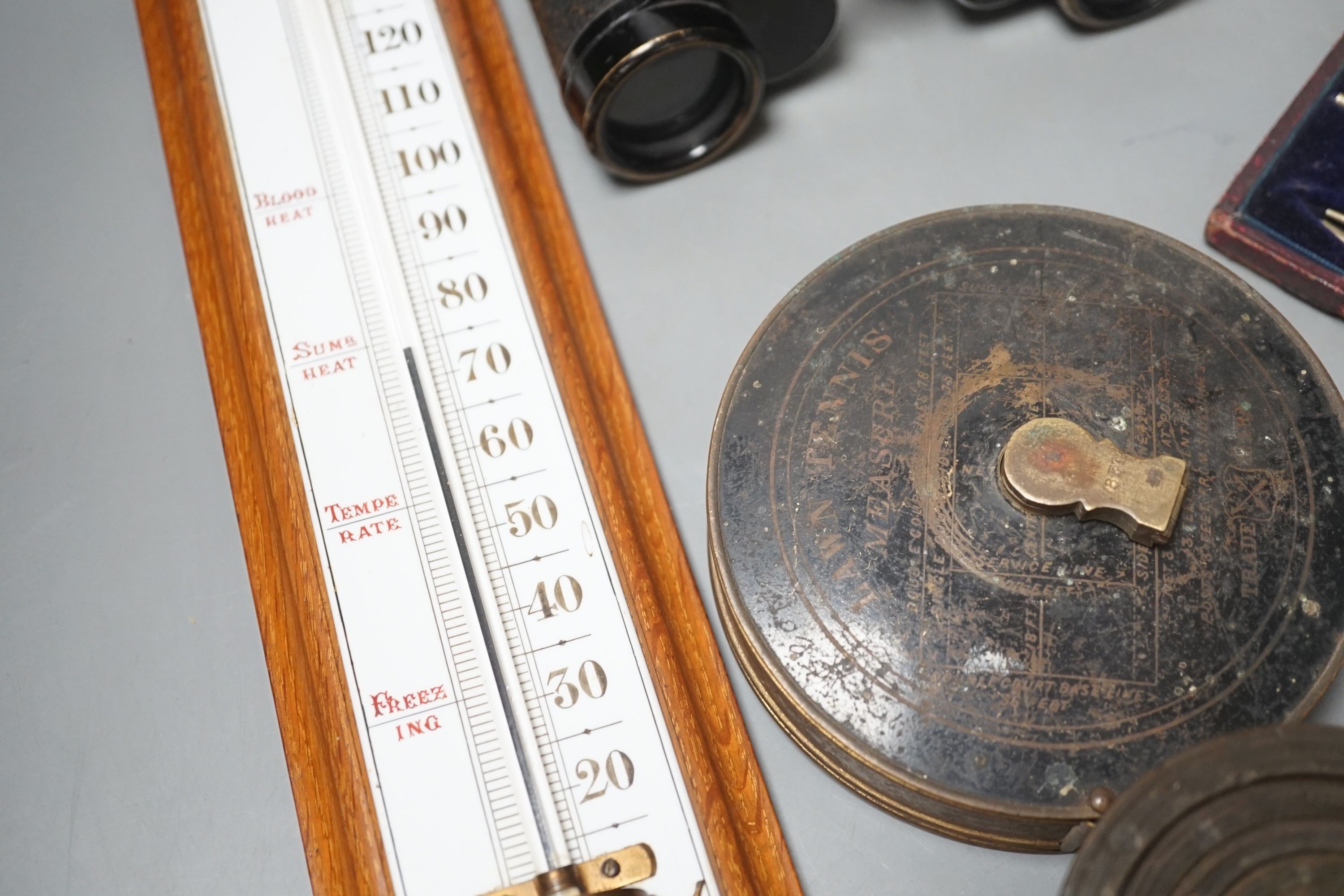 Cased drawing instruments, binoculars, weights, Lawn Tennis tape etc. including a Negretti and Zambra thermometer